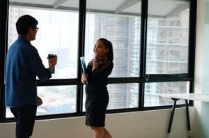 A man and a woman standing and having a conversation.