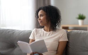 A lady sitting alone with a book. An introvert