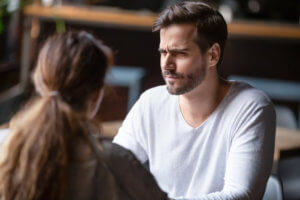 A man looking at a woman with a doubtful expression